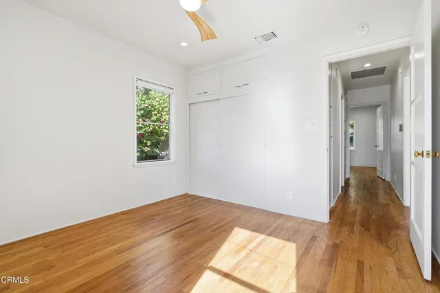 a view of a room with wooden floor and a bathroom