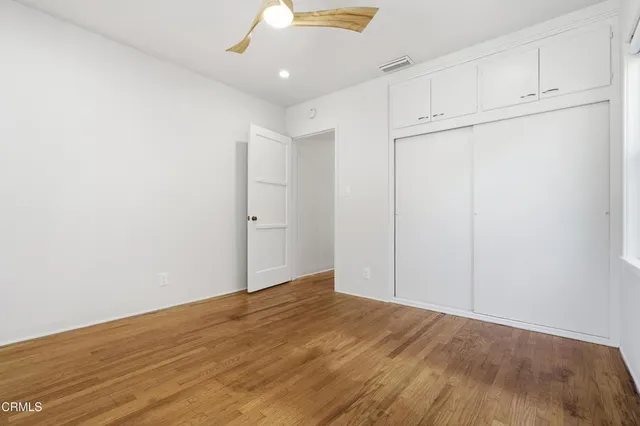 an empty room with wooden floor