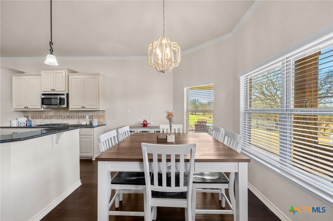 957 County Road 3350 Kempner, TX 76539 - Photo 11 of 35 a view of a dining room with furniture a chandelier and wooden floor