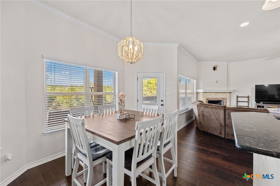 957 County Road 3350 Kempner, TX 76539 - Photo 12 of 35 a view of a dining room with furniture a chandelier and wooden floor