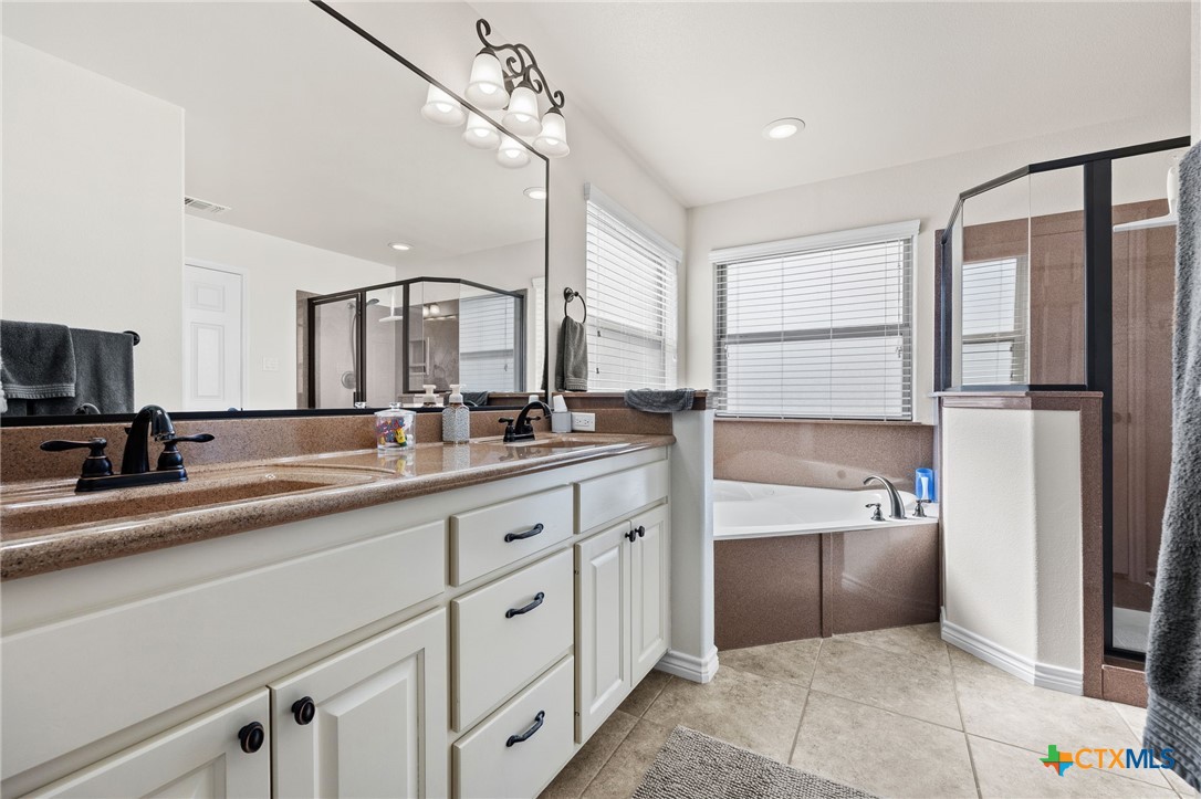 957 County Road 3350 Kempner, TX 76539 - Photo 19 of 35 a spacious bathroom with a double vanity sink a mirror and a bathtub