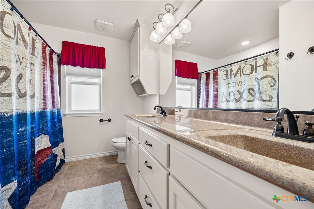 957 County Road 3350 Kempner, TX 76539 - Photo 24 of 35 a bathroom with a sink a vanity and a mirror