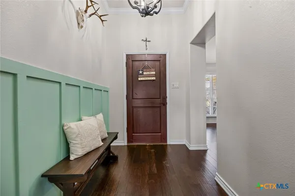 a view of hallway with furniture and wooden floor