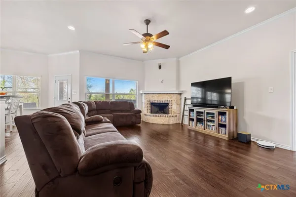 a living room with furniture a flat screen tv and a fireplace
