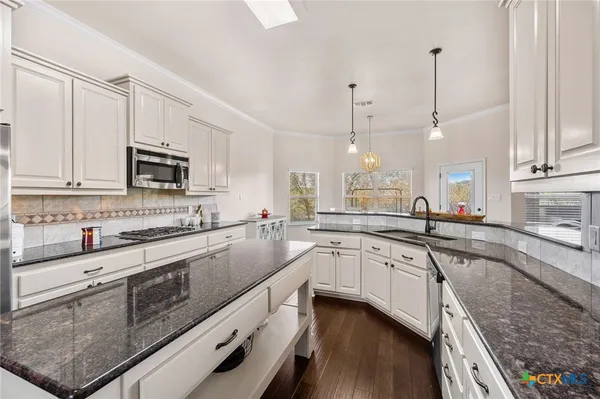 a large kitchen with granite countertop lots of counter top space