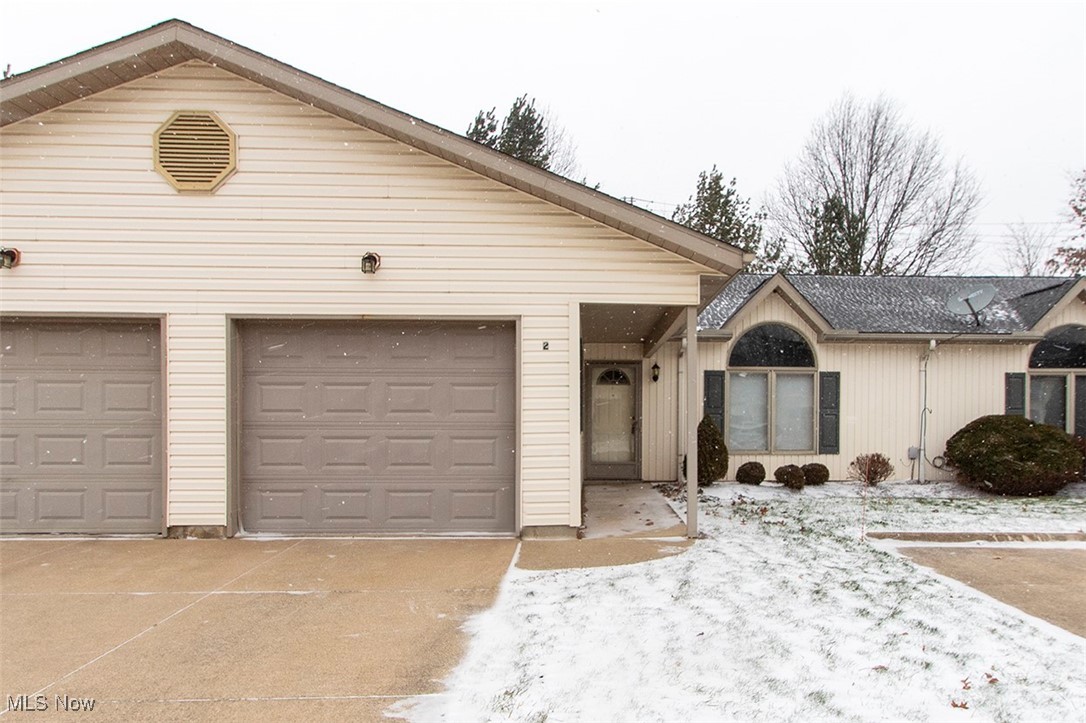Ranch-style house with a garage and driveway
