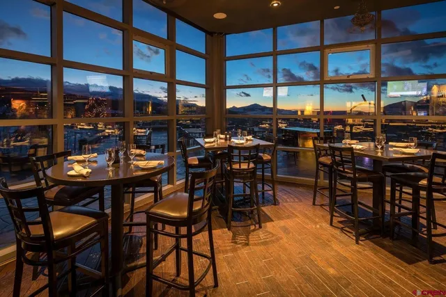 a view of a dining table and chairs in the patio of a house