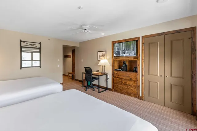 a bedroom with furniture and a window