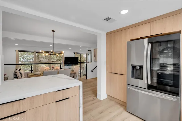 a kitchen with a sink a counter top space stainless steel appliances and cabinets