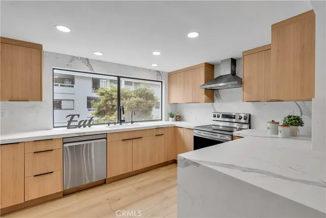 a kitchen with stainless steel appliances granite countertop wooden cabinets and a granite counter tops