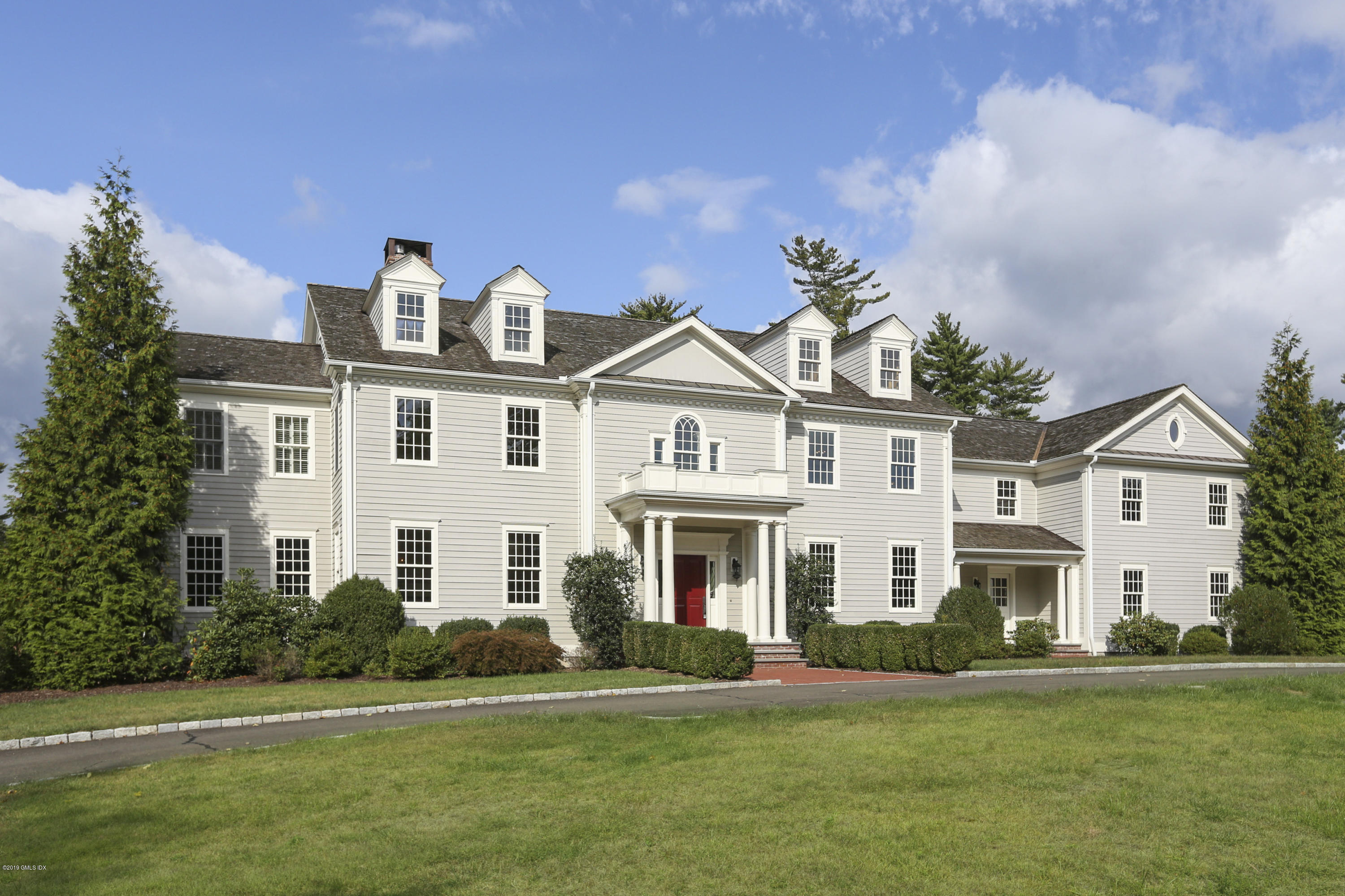 16 Boulder Brook Road Greenwich, CT 06830 - Photo 1 of 1 a front view of a house with a garden