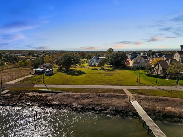 a aerial view of a house with a big yard and large trees