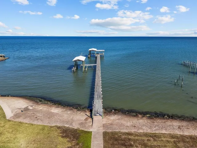 a living room with furniture potted plant and a large window