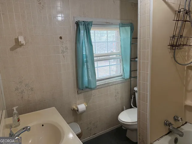a bathroom with a bathtub a toilet and a shower
