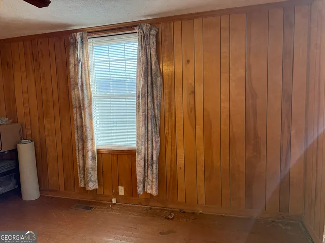 a view of a storage & utility room with refrigerator