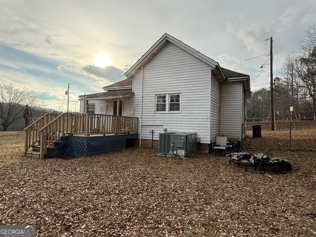 a view of backyard with a deck and furniture