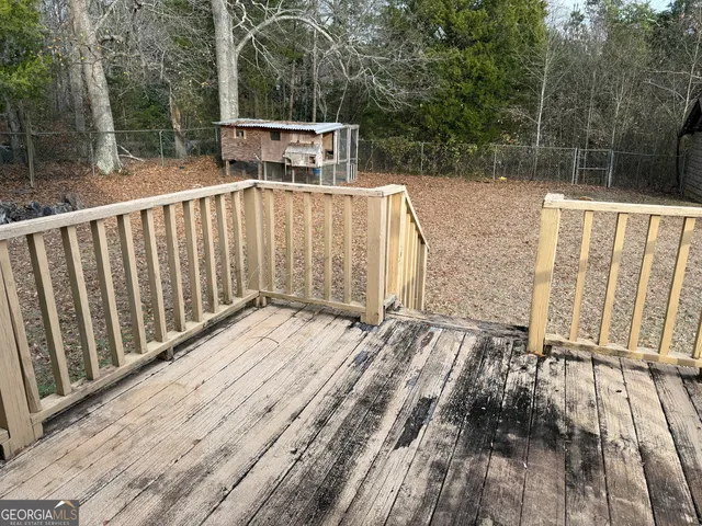 a backyard of a house with large trees and barbeque oven