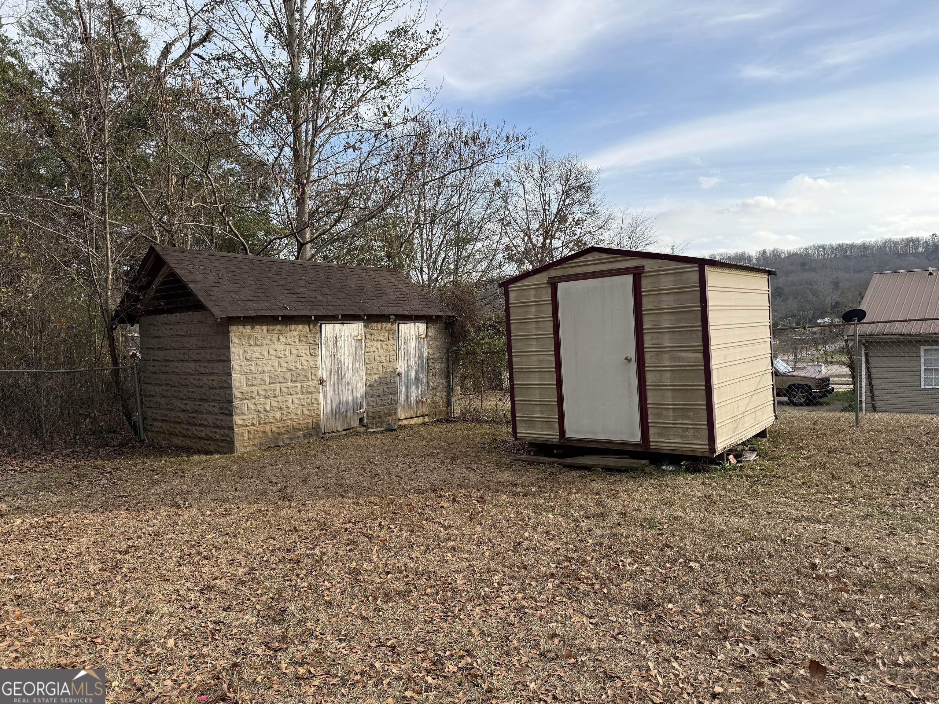 19 Truitt Street Manchester, GA 31816 - Photo 24 of 31 a backyard of a house with large trees and barbeque oven