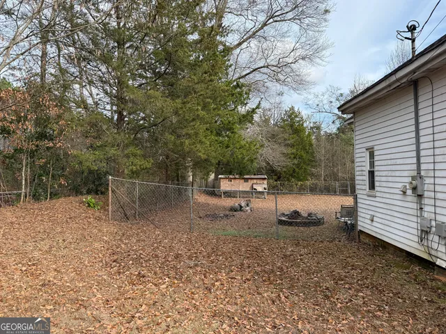 a view of a wooden fence with a bench in the patio