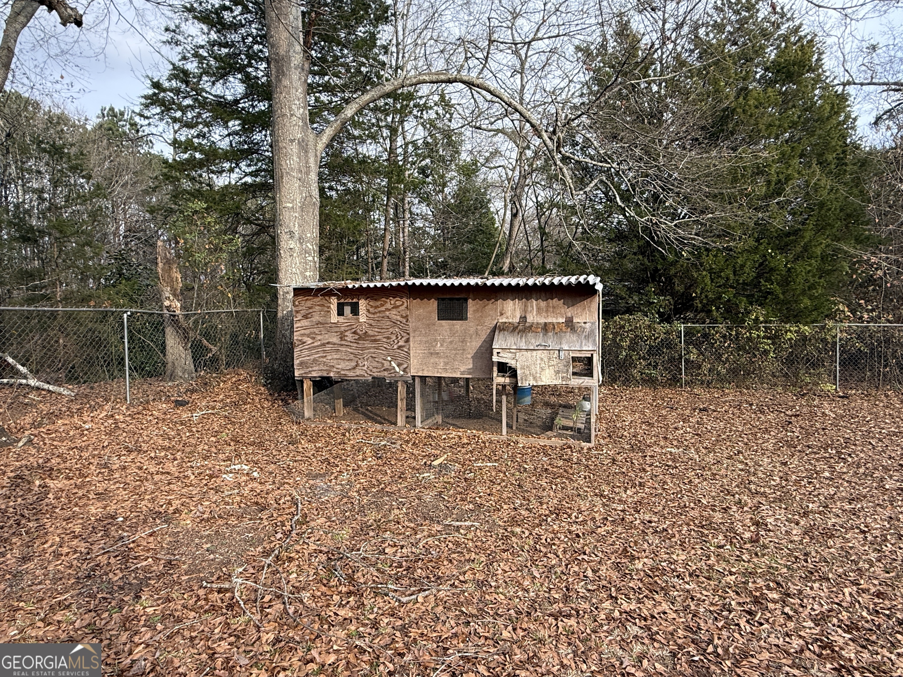 19 Truitt Street Manchester, GA 31816 - Photo 29 of 31 a view of a wooden fence with a bench in the patio