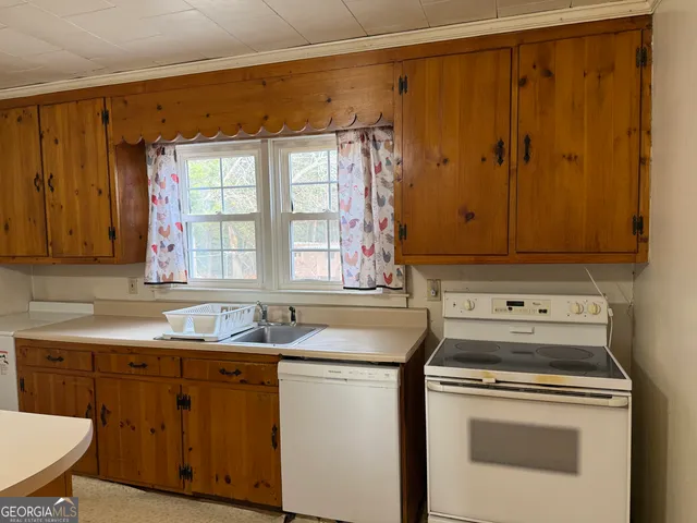 a kitchen with a sink stove and cabinets