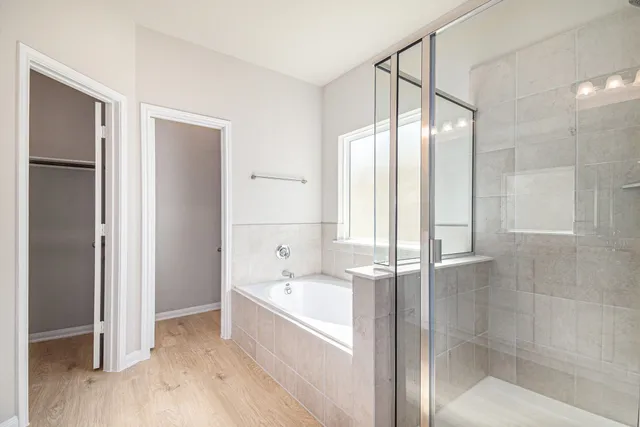 a bathroom with a bathtub and a shower