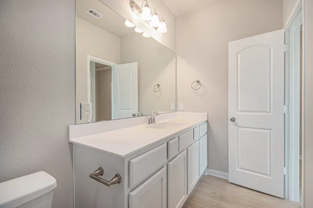 a bathroom with a sink vanity and a mirror