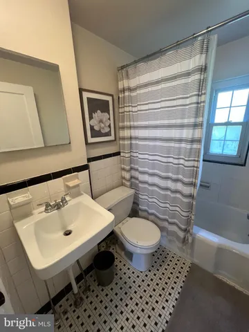 a bathroom with a sink toilet a mirror and shower