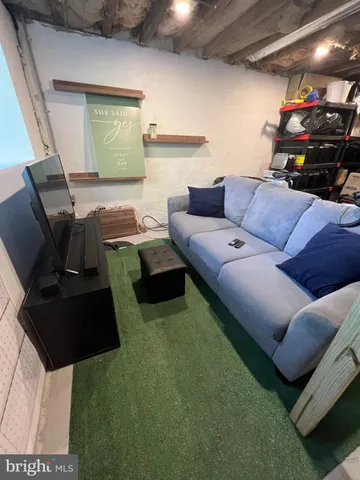 a living room with couch and a mirror