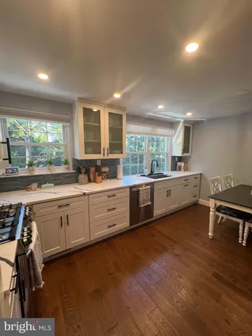 a large kitchen with kitchen island granite countertop a large window and counter space
