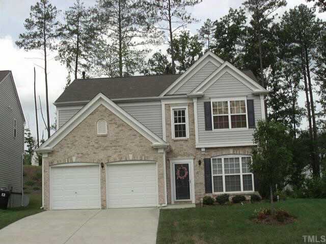 207 Willingham Road Morrisville, NC 27560 - Photo 1 of 1 a view of a yard in front of a house with a large tree