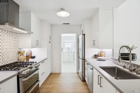 a kitchen with a stove and a refrigerator