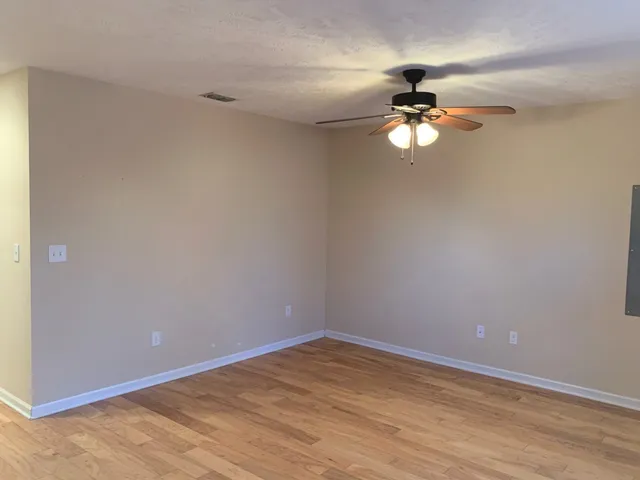 a view of a chandelier fan and hardwood floor