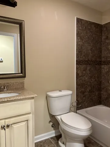 a white toilet sitting next to a bathroom sink