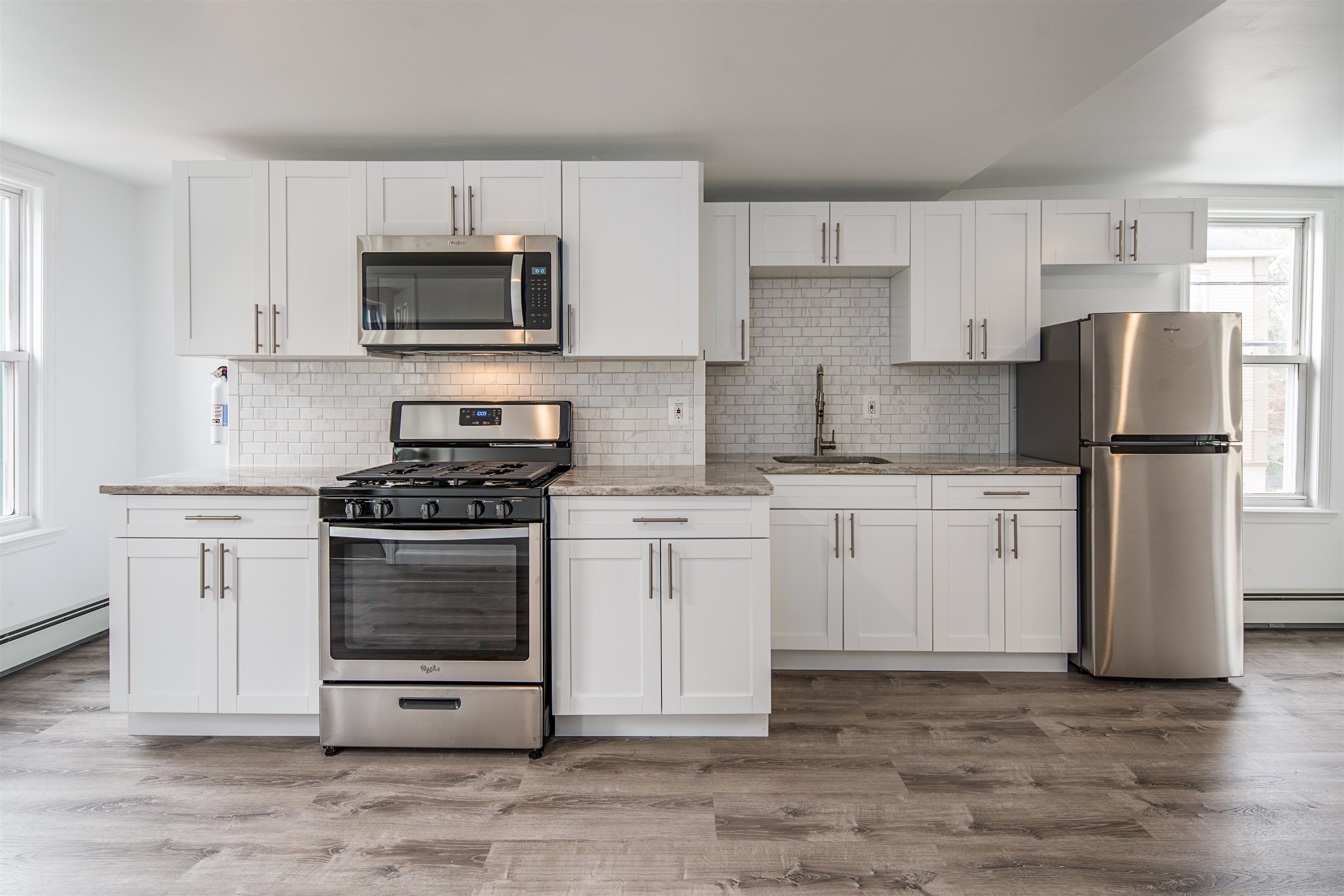 74 Colgate Street, Unit 2 Jersey City, NJ 07302 - Photo 2 of 10 a kitchen with stainless steel appliances granite countertop a stove a refrigerator and a microwave