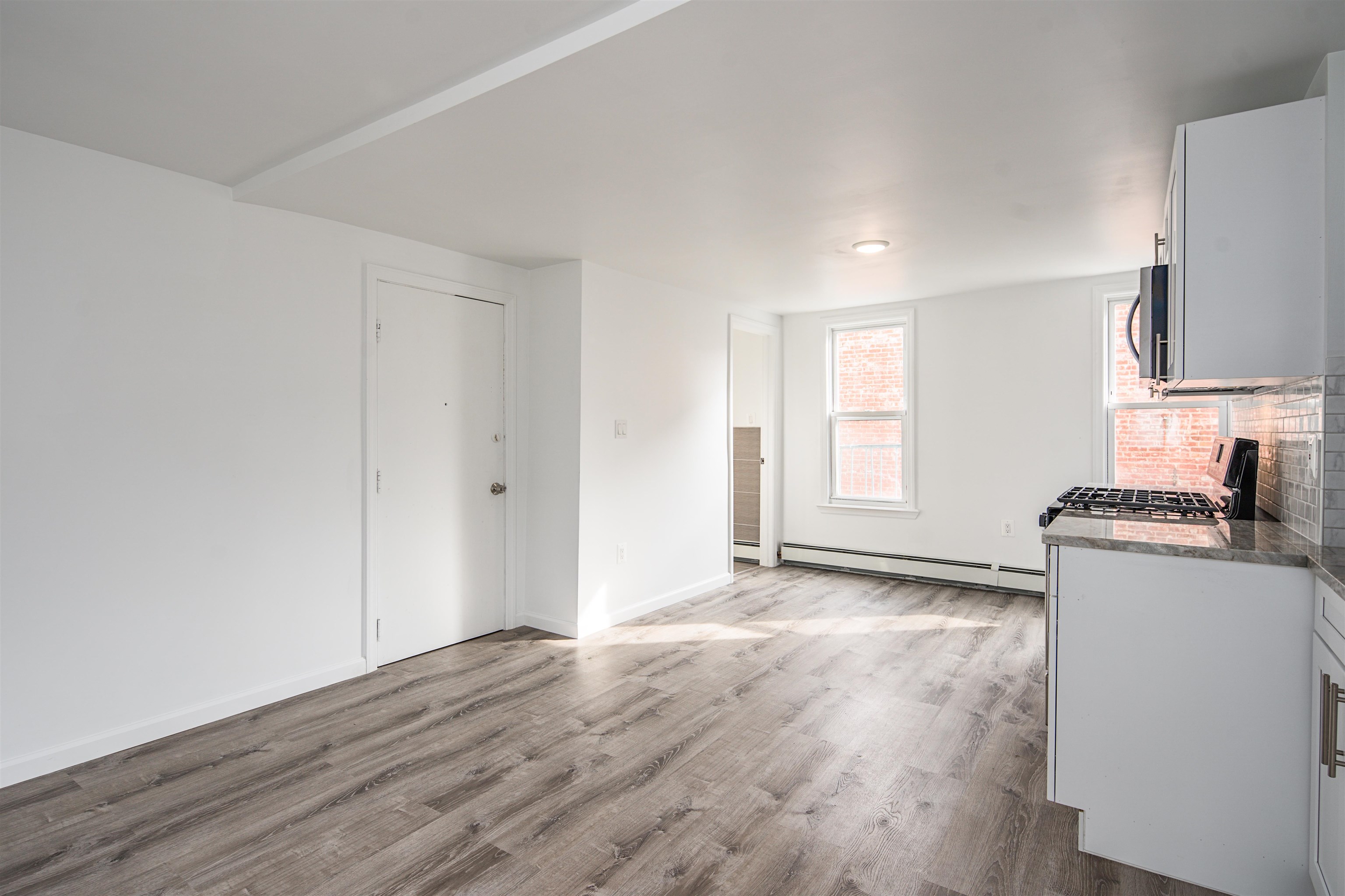 74 Colgate Street, Unit 2 Jersey City, NJ 07302 - Photo 9 of 10 a view of a kitchen with wooden floor and a sink