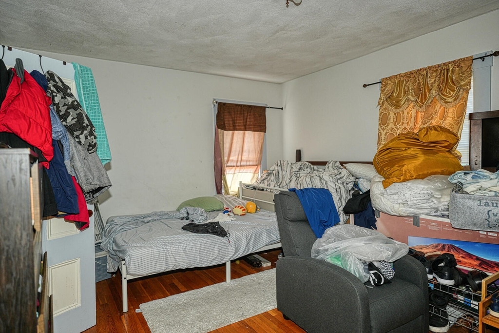 7 Prospect Street Woburn, MA 01801 - Photo 11 of 40 a living room with furniture and a bed