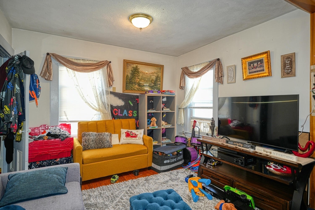 7 Prospect Street Woburn, MA 01801 - Photo 12 of 40 a living room with furniture and a flat screen tv