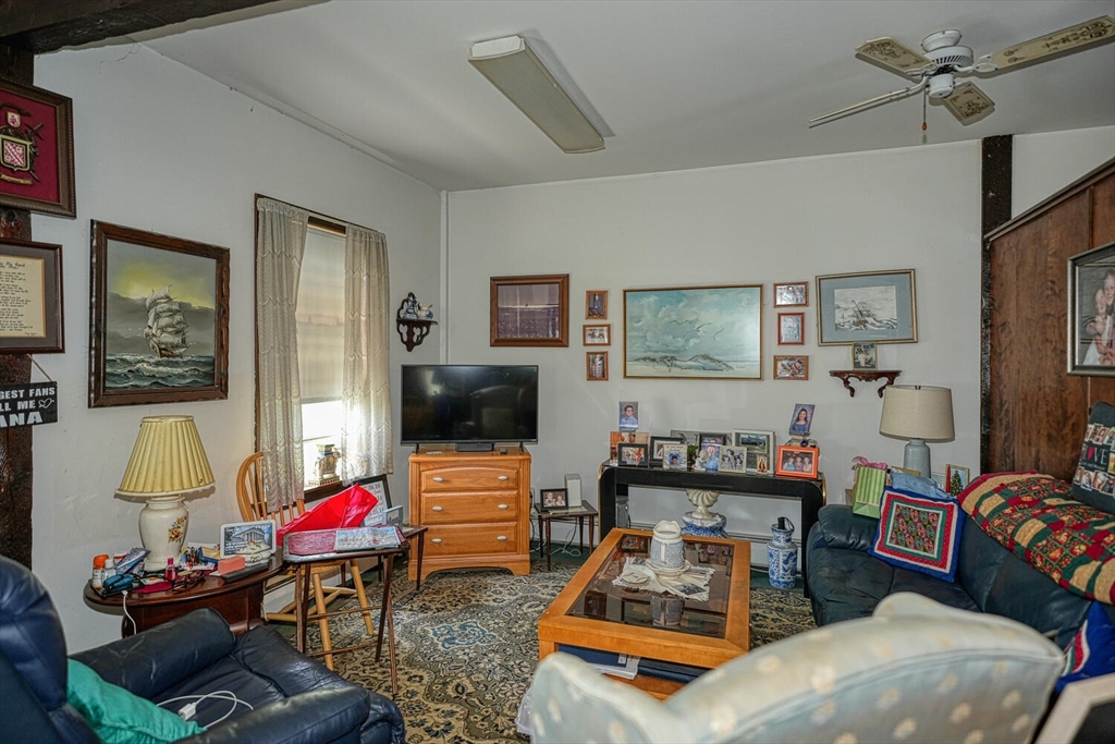7 Prospect Street Woburn, MA 01801 - Photo 15 of 40 a living room with furniture and a flat screen tv