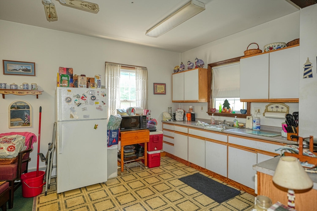 7 Prospect Street Woburn, MA 01801 - Photo 17 of 40 a kitchen with a sink stove and refrigerator