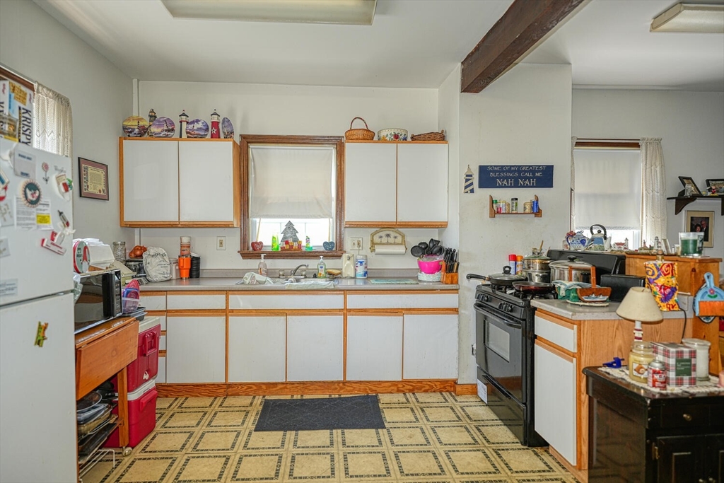 7 Prospect Street Woburn, MA 01801 - Photo 19 of 40 a kitchen with granite countertop a sink stove and cabinets