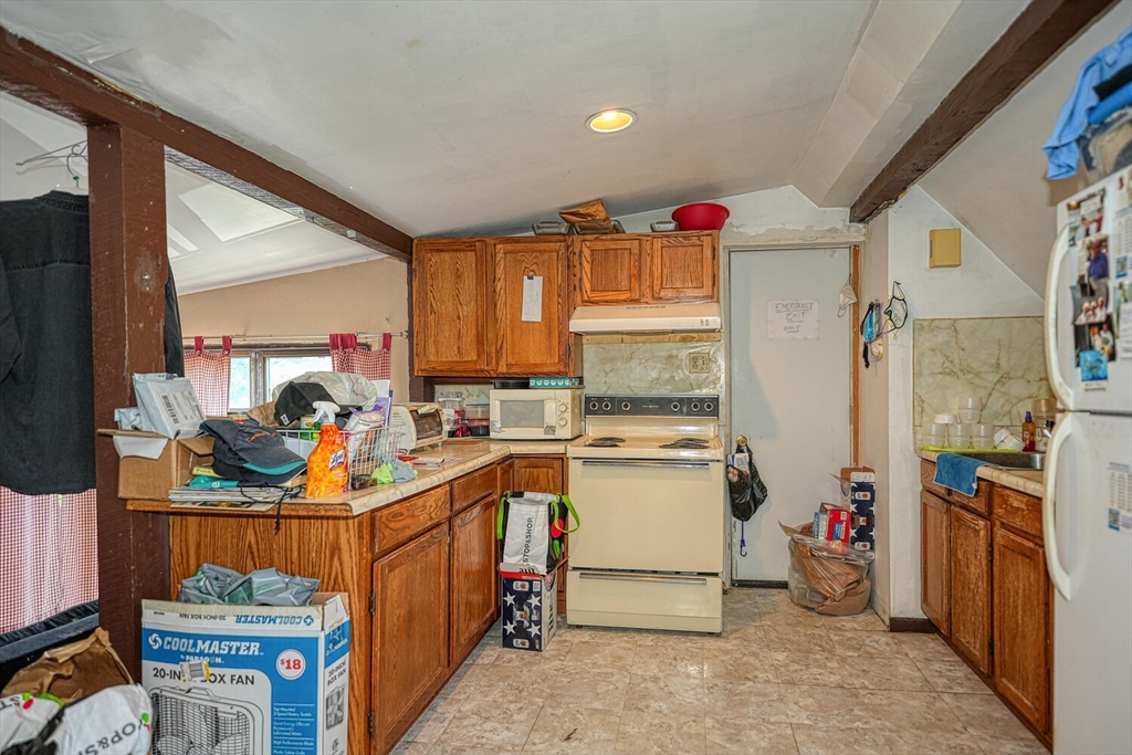 7 Prospect Street Woburn, MA 01801 - Photo 20 of 40 a utility room with stainless steel appliances a sink and a refrigerator