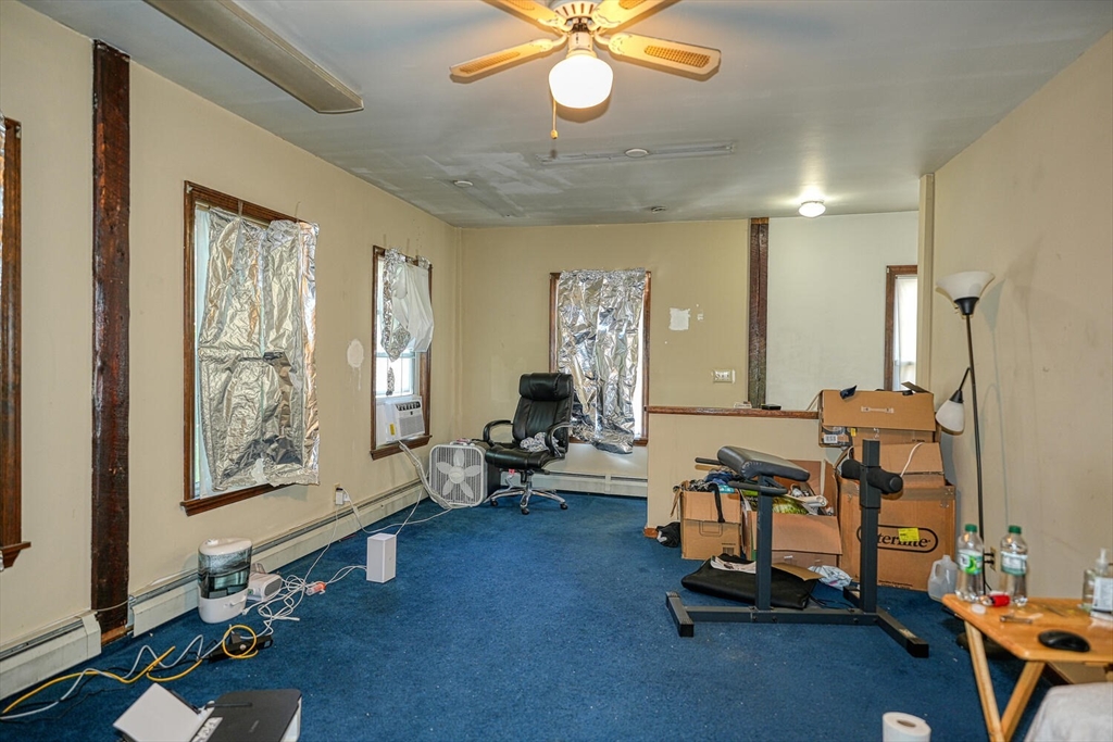 7 Prospect Street Woburn, MA 01801 - Photo 26 of 40 a living room with furniture and a chandelier