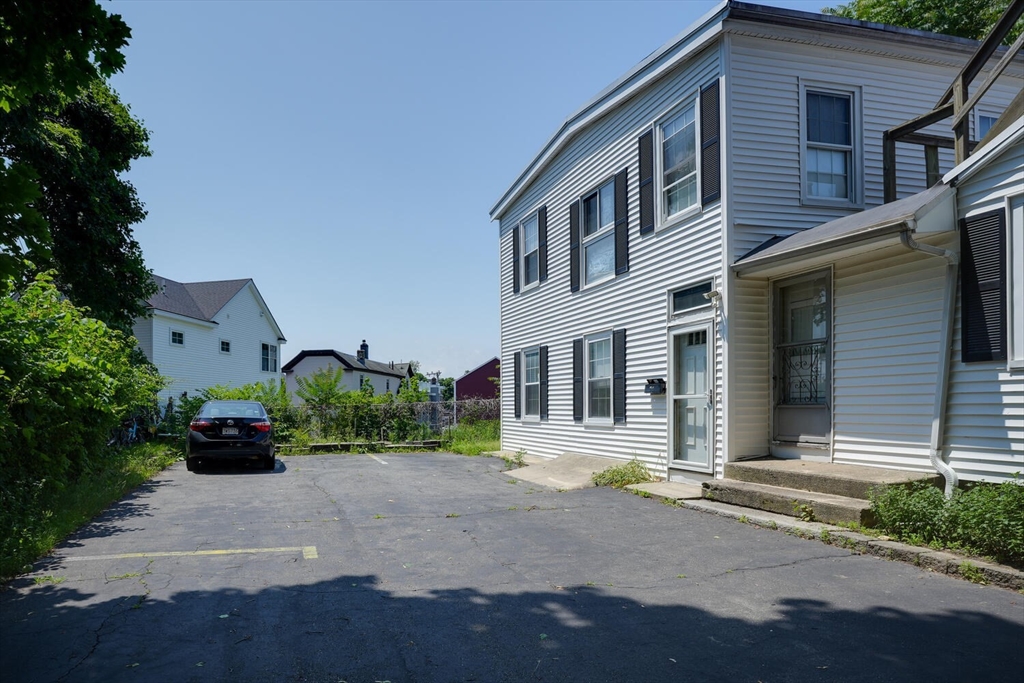 7 Prospect Street Woburn, MA 01801 - Photo 3 of 40 a front view of a house with a yard