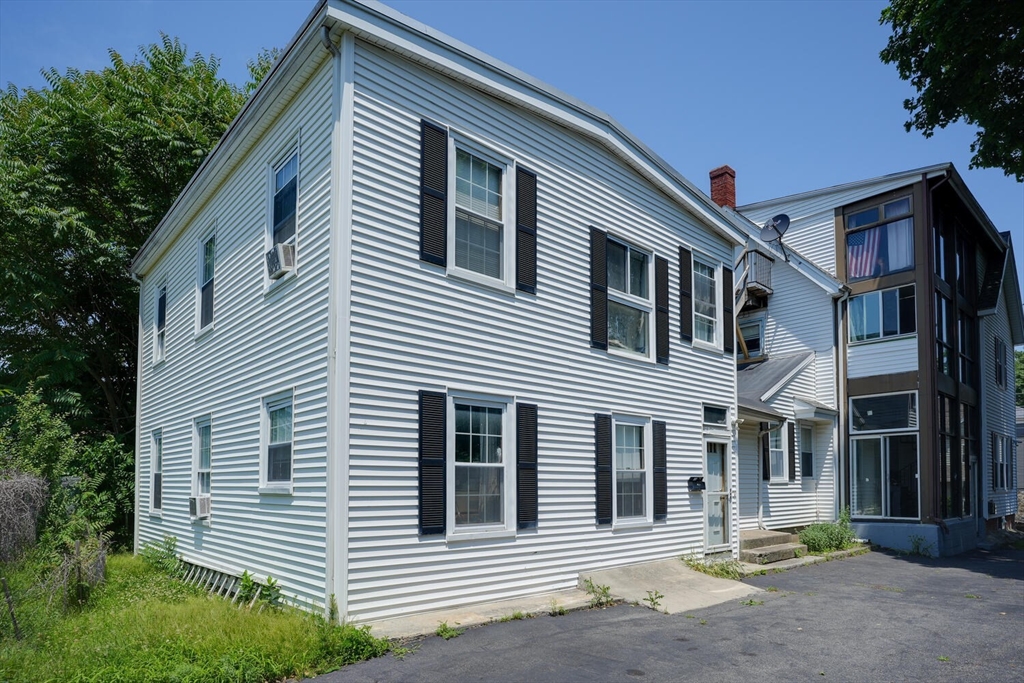 7 Prospect Street Woburn, MA 01801 - Photo 35 of 40 a front view of a house with a garden