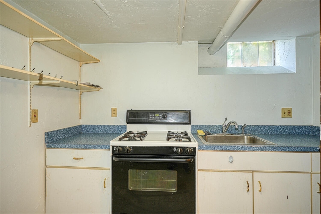 7 Prospect Street Woburn, MA 01801 - Photo 9 of 40 a white stove top oven sitting inside of a kitchen