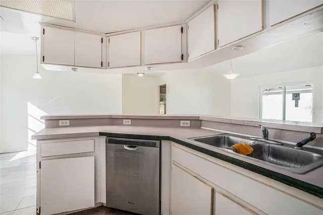 a kitchen with a sink and cabinets