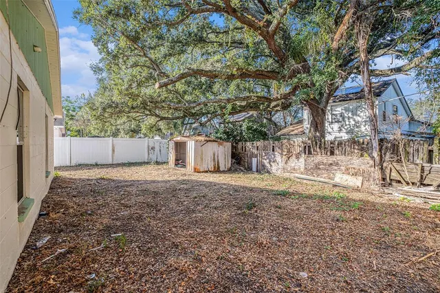 a backyard of a house with a trees and a barn