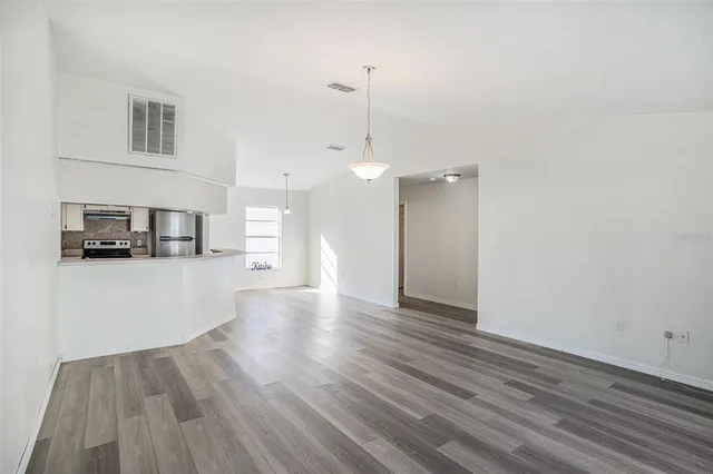 a view of a kitchen with a dishwasher and wooden floor
