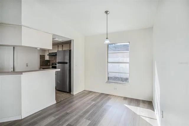 a view of a kitchen with an empty space and a window